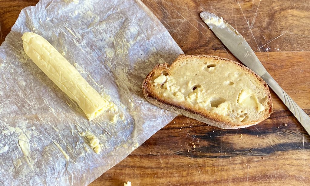 Cultured butter next to sourdough slice