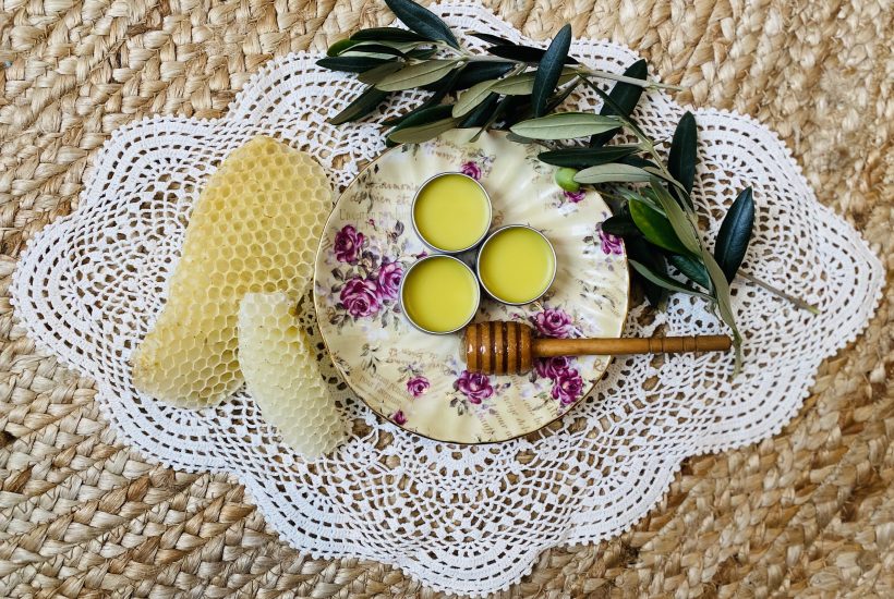Lip balm on plate with beeswax and olive branch